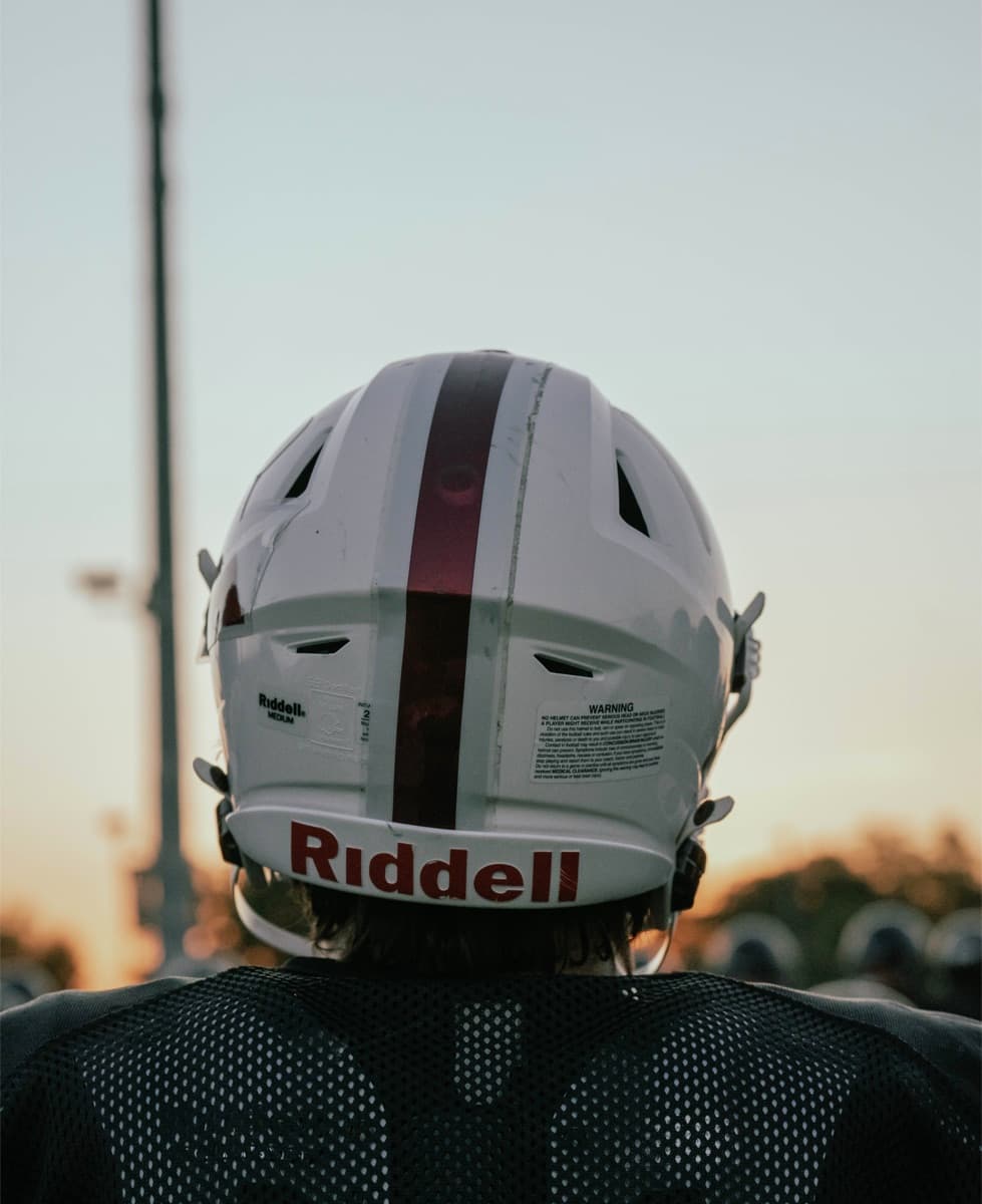 Football player from behind at sunset