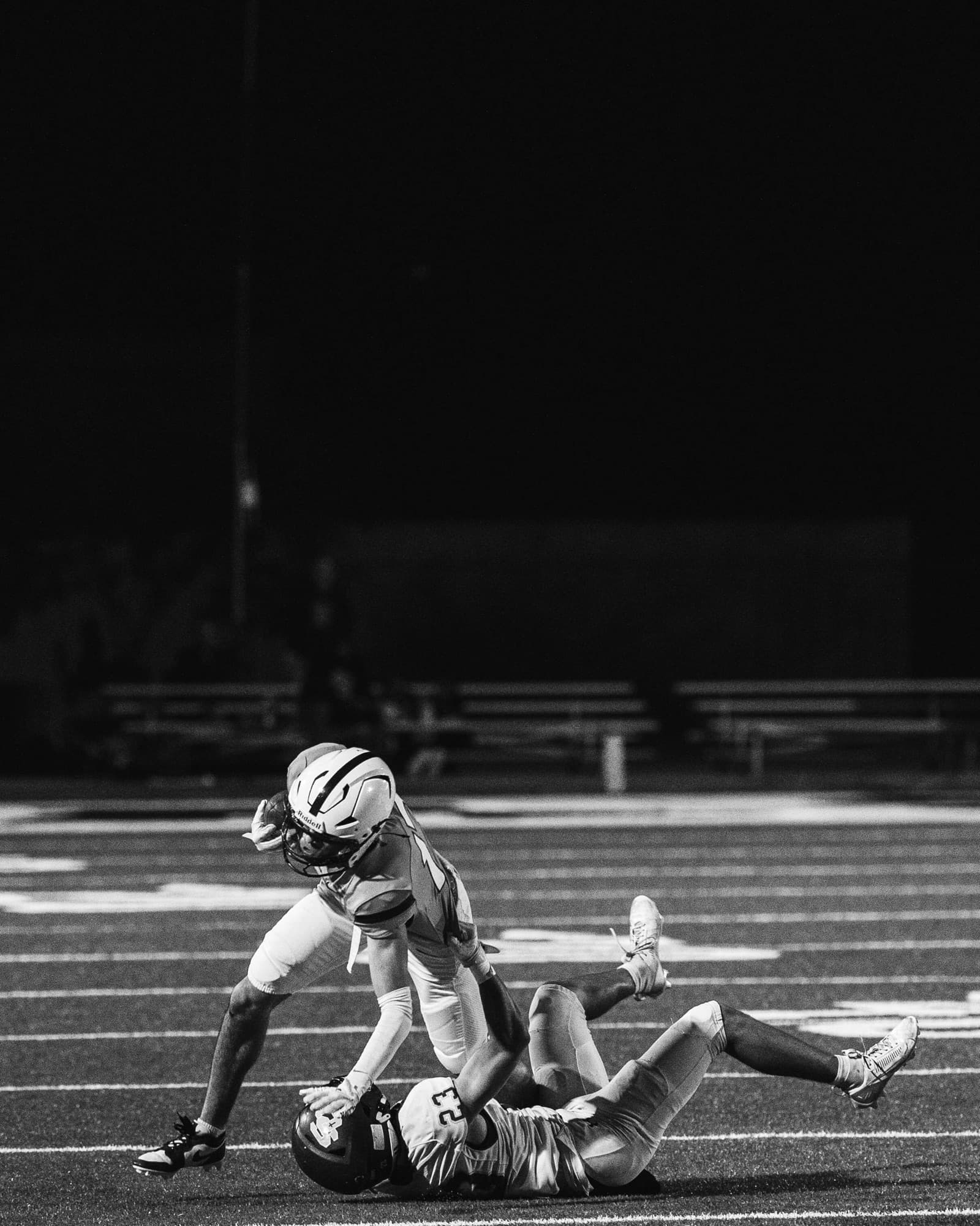 Casteel football tackle under the lights
